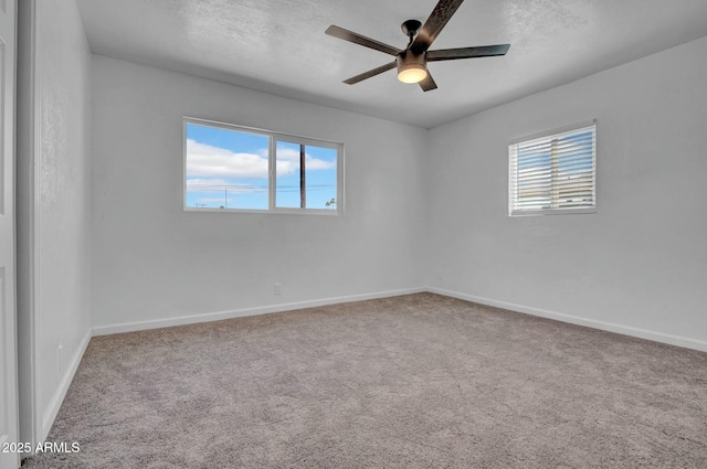 spare room featuring baseboards, ceiling fan, a textured ceiling, and carpet flooring