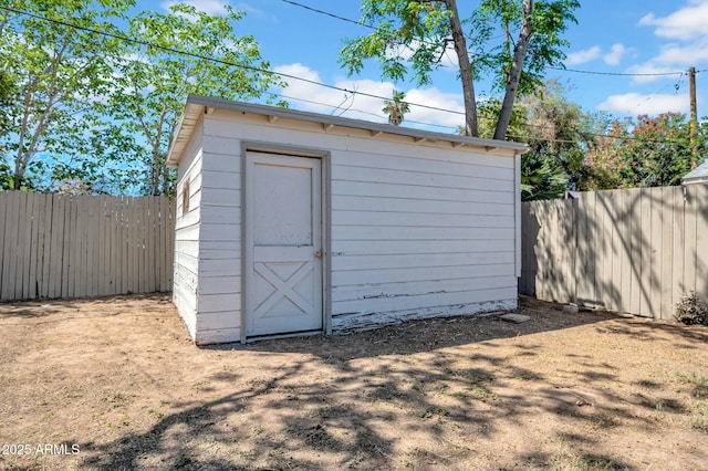 view of shed with fence