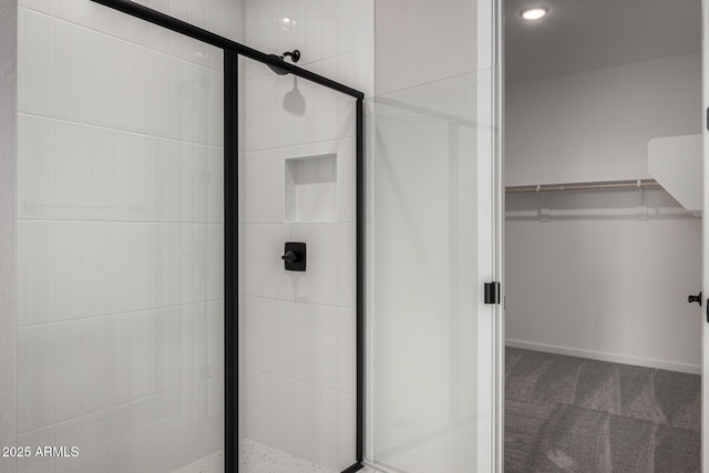 bathroom featuring a shower with shower door