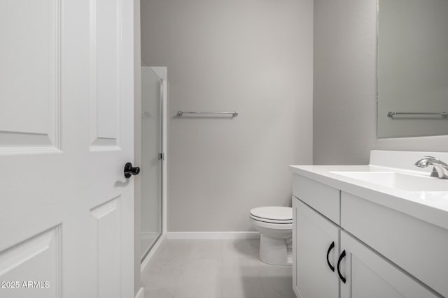 bathroom featuring vanity, toilet, and a shower with door