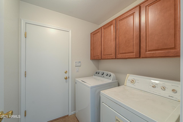 laundry area with washer and clothes dryer and cabinet space