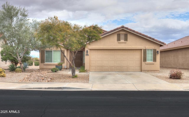 view of front of property with a tiled roof, stucco siding, driveway, and an attached garage