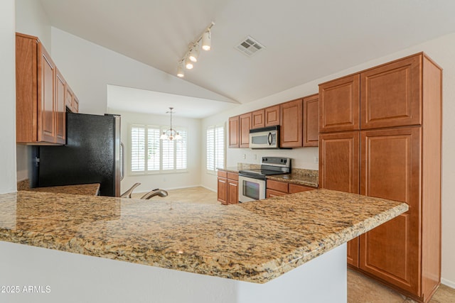 kitchen with visible vents, appliances with stainless steel finishes, a peninsula, brown cabinetry, and lofted ceiling