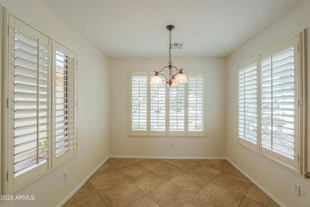 unfurnished dining area featuring a chandelier, visible vents, baseboards, and light tile patterned floors