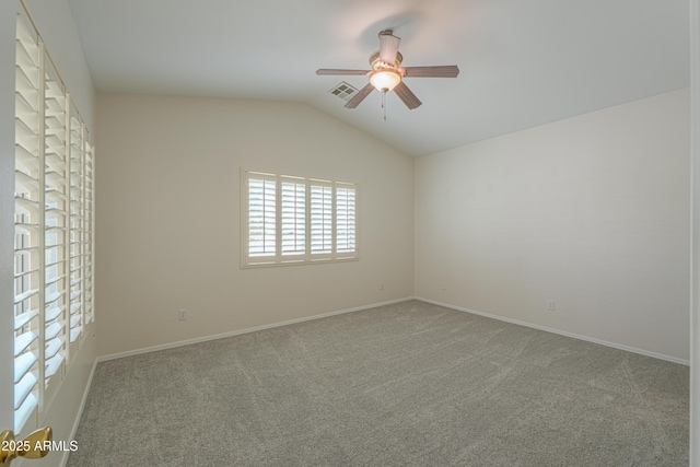 unfurnished room with baseboards, visible vents, lofted ceiling, ceiling fan, and carpet flooring