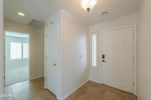 entryway featuring light tile patterned flooring, visible vents, and baseboards