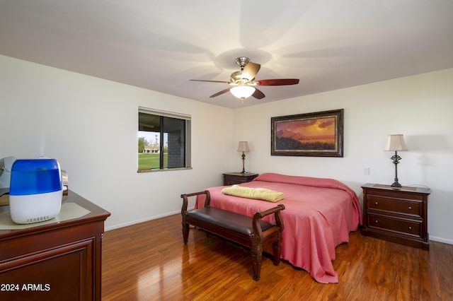 bedroom with ceiling fan and dark wood-type flooring