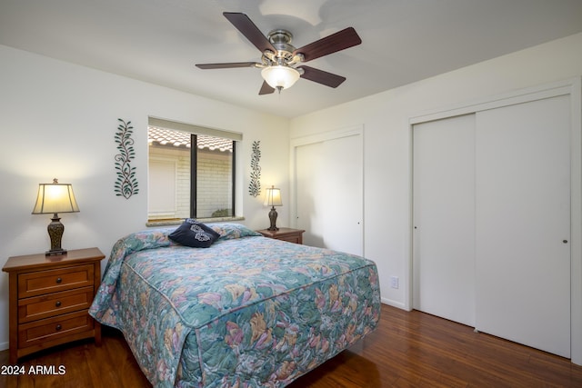 bedroom with dark hardwood / wood-style floors and ceiling fan