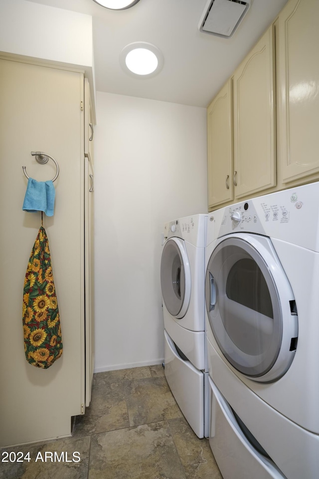 laundry room with cabinets and separate washer and dryer