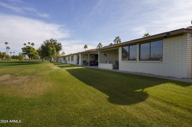 rear view of property with a yard