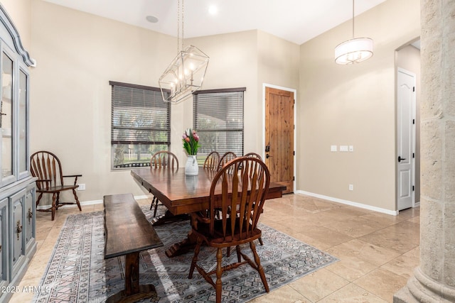 dining space with baseboards, light tile patterned floors, and an inviting chandelier