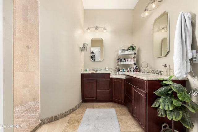 full bathroom with a sink, tile patterned flooring, walk in shower, and double vanity