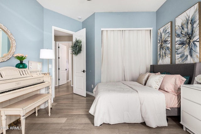 bedroom featuring baseboards and wood finished floors