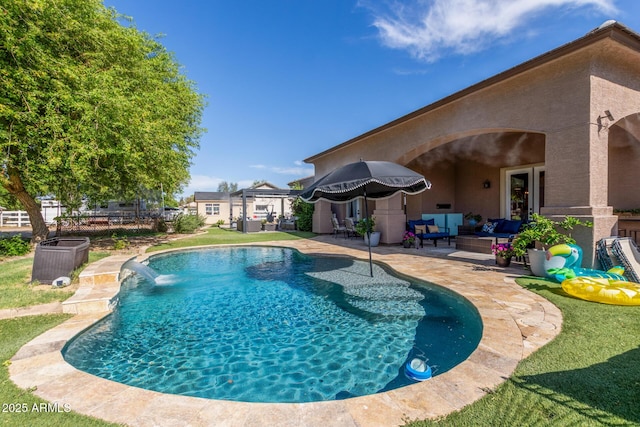 pool featuring a patio and an outdoor living space