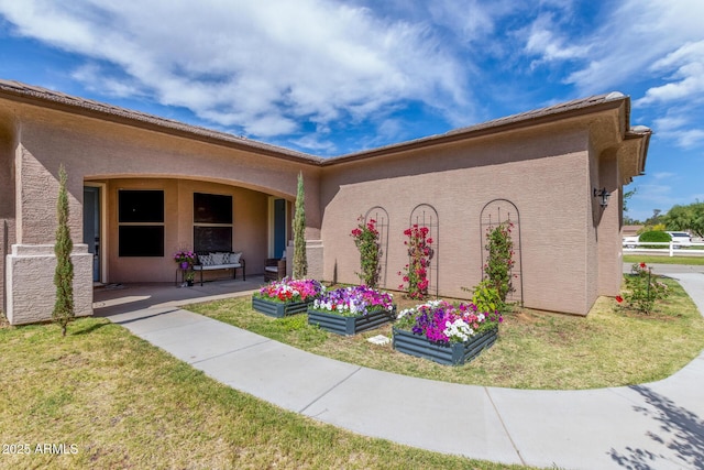 view of home's exterior featuring a lawn, stucco siding, and cooling unit