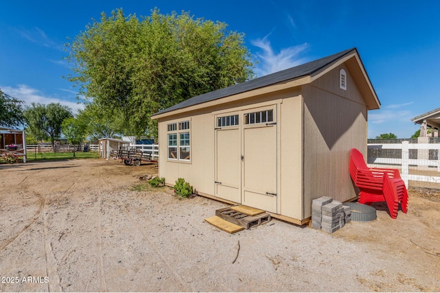 view of shed with fence