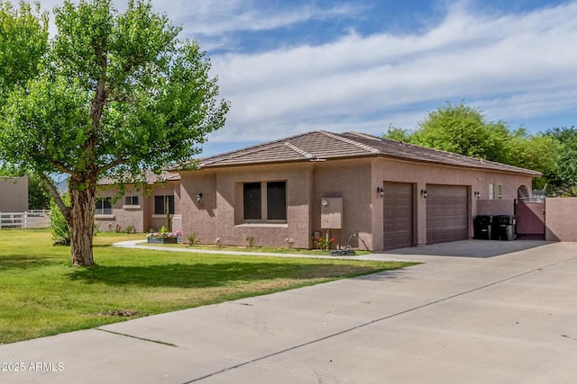 ranch-style house with driveway, fence, a front lawn, an attached garage, and stucco siding