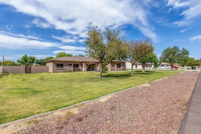 single story home featuring fence and a front lawn