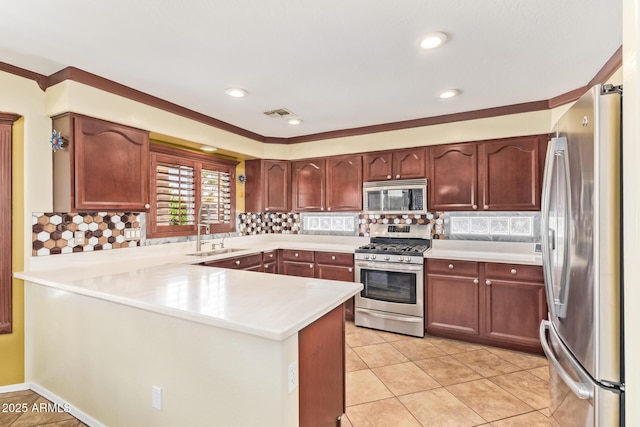 31453 N Blackfoot Dr, San Tan Valley, AZ 85143 - kitchen featuring appliances with stainless steel finishes, a sink, a peninsula, light countertops, and tasteful backsplash