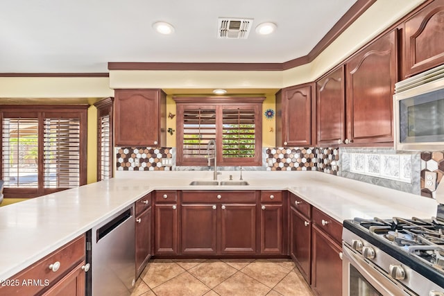 31453 N Blackfoot Dr, San Tan Valley, AZ 85143 - kitchen featuring a sink, stainless steel appliances, light countertops, light tile patterned floors, and ornamental molding