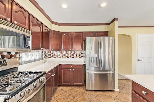 31453 N Blackfoot Dr, San Tan Valley, AZ 85143 - kitchen with stainless steel appliances, light countertops, ornamental molding, light tile patterned flooring, and decorative backsplash