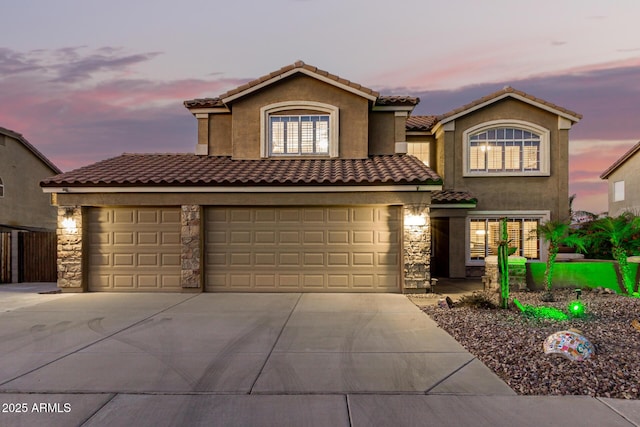 31453 N Blackfoot Dr, San Tan Valley, AZ 85143 - mediterranean / spanish home with concrete driveway, stone siding, stucco siding, a tile roof, and an attached garage