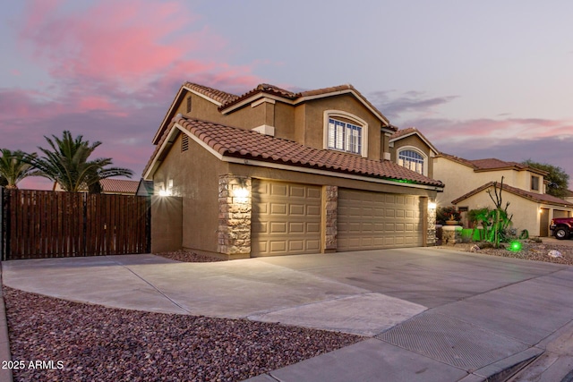 31453 N Blackfoot Dr, San Tan Valley, AZ 85143 - mediterranean / spanish home with driveway, stucco siding, an attached garage, stone siding, and a tiled roof