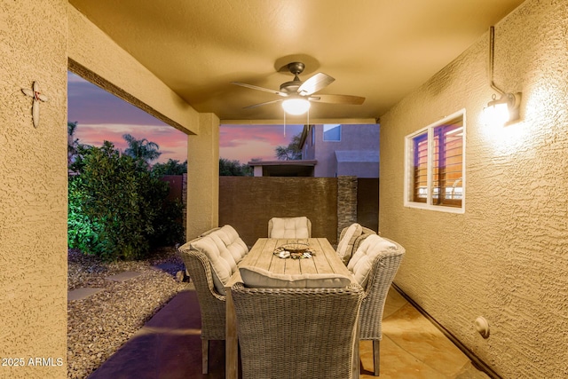 31453 N Blackfoot Dr, San Tan Valley, AZ 85143 - patio terrace at dusk featuring a ceiling fan, outdoor dining space, and a patio area