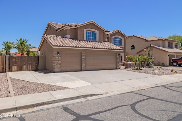 31453 N Blackfoot Dr, San Tan Valley, AZ 85143 - mediterranean / spanish house featuring stucco siding, stone siding, concrete driveway, a tile roof, and a garage