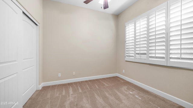 unfurnished bedroom featuring baseboards, carpet flooring, ceiling fan, and a closet