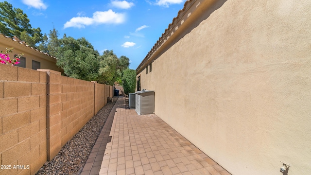 view of property exterior with a patio, fence, and stucco siding