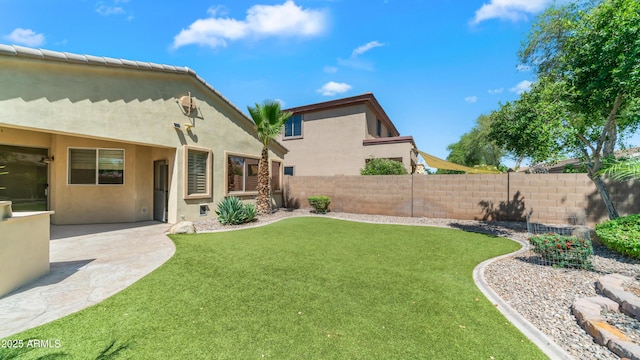 view of yard with fence and a patio
