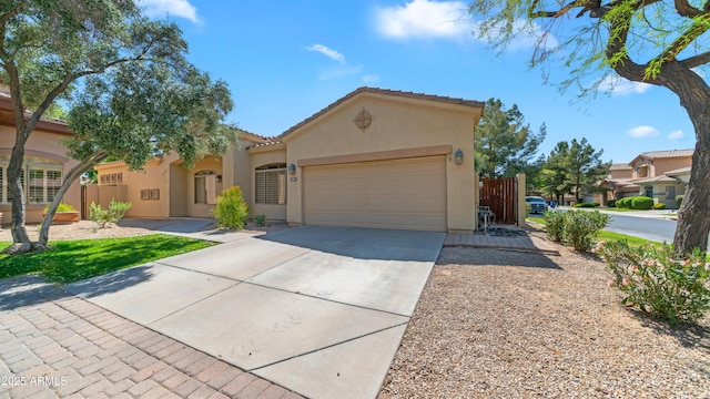 view of front of house featuring a garage, stucco siding, a tile roof, and concrete driveway