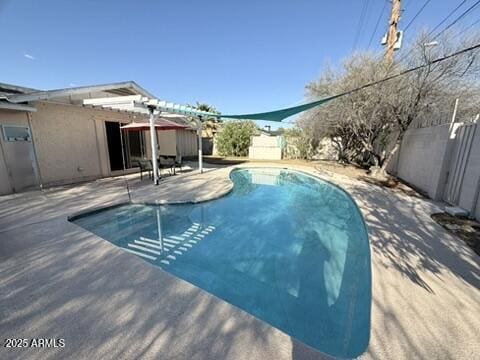 outdoor pool with a pergola, a patio area, and a fenced backyard