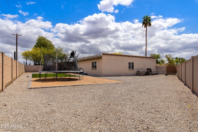 858 W Knowles Cir, Mesa, AZ 85210 - rear view of house with a trampoline and a fenced backyard