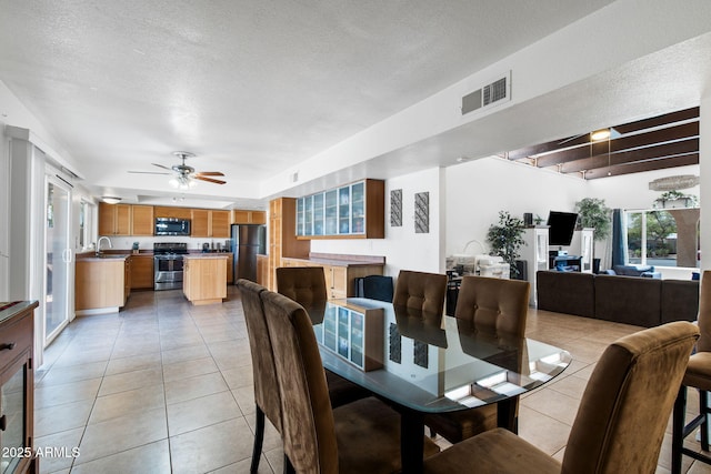 858 W Knowles Cir, Mesa, AZ 85210 - dining room with light tile patterned floors, ceiling fan, and a textured ceiling