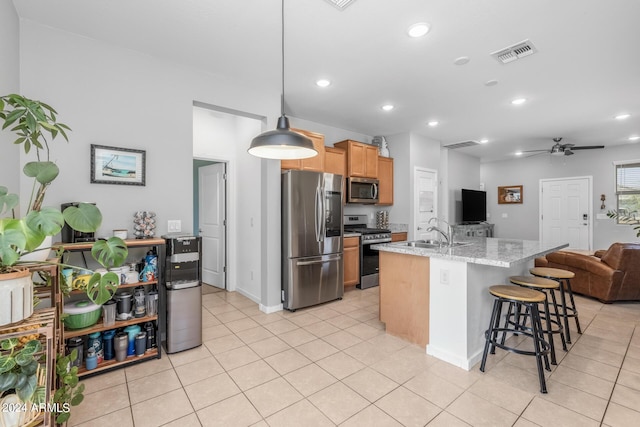 kitchen with visible vents, open floor plan, light tile patterned flooring, stainless steel appliances, and a sink