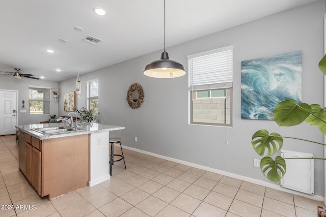 kitchen featuring a sink, visible vents, baseboards, and recessed lighting