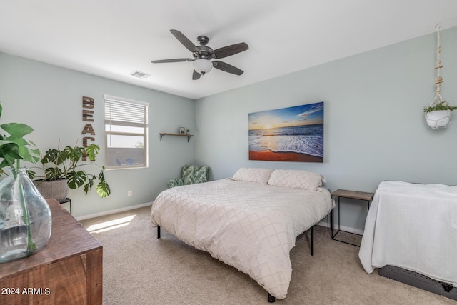 carpeted bedroom featuring baseboards, visible vents, and ceiling fan