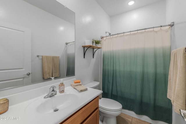 bathroom with tile patterned flooring, vanity, and toilet