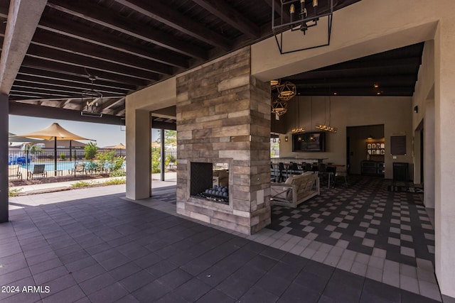 view of patio / terrace featuring a fenced in pool, fence, and an outdoor stone fireplace