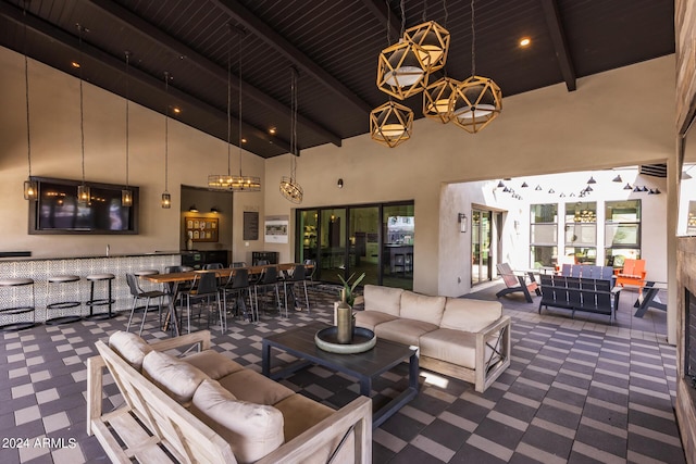 living area with beamed ceiling