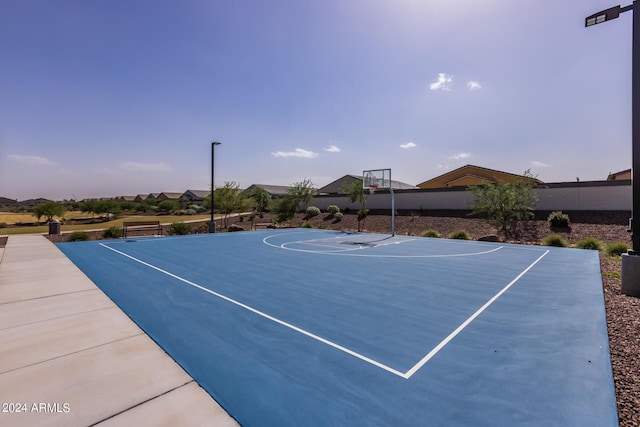 view of basketball court with community basketball court and fence