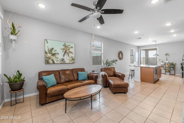 tiled living room with sink and ceiling fan