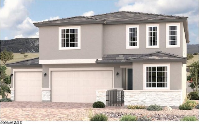 traditional-style house with stone siding, an attached garage, and stucco siding
