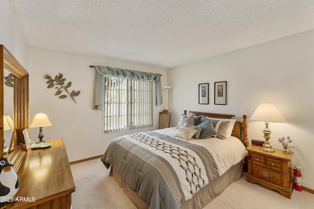 bedroom featuring light colored carpet and a textured ceiling