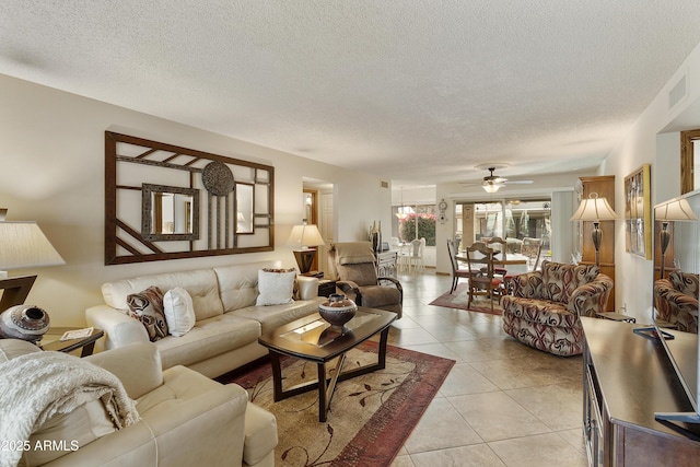 living room featuring light tile patterned flooring and a textured ceiling