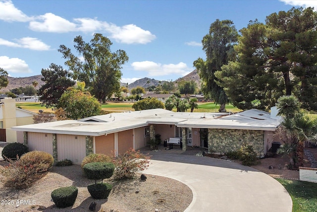 view of front of home with a mountain view and driveway