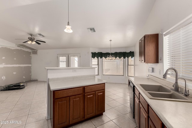 kitchen featuring a wealth of natural light, sink, hanging light fixtures, and light tile patterned floors