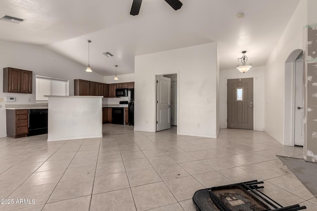 kitchen with pendant lighting, a center island, light tile patterned flooring, and black appliances